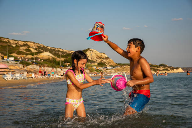 happy girl and boy play with toys on beach vacation