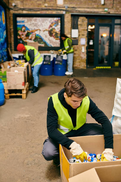 istock Young volunteers sorting recyclables in a community space for eco-friendly efforts 2173086770
