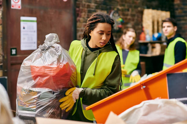 Young volunteers actively sorting garbage in a community center for eco-initiatives
