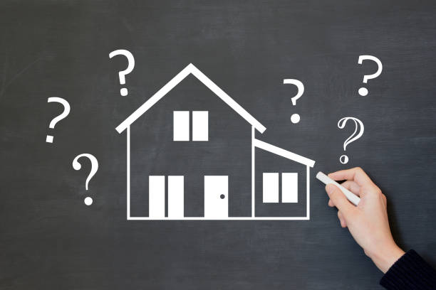 istock Human’s hand drawing home illustration and question marks on blackboard 2173087001