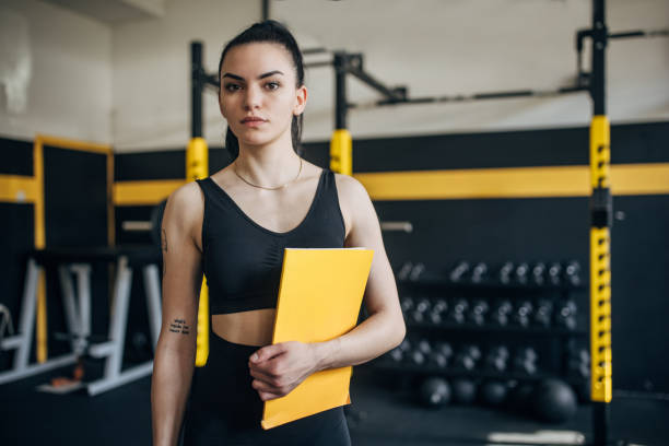 istock Calm and focused coach with a yellow folder in gym 2173087779