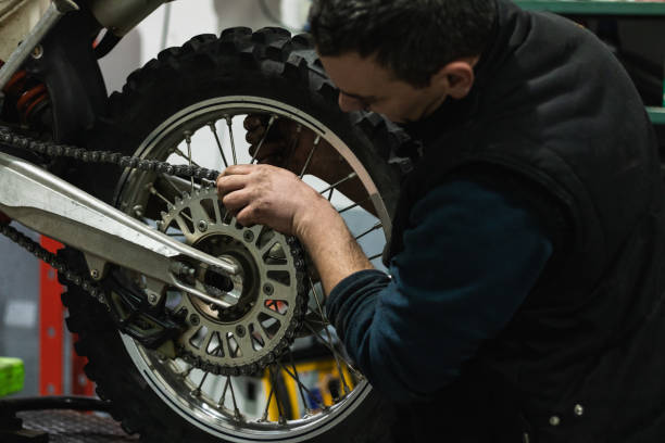 istock Crop mechanic changing motorbike chain in workshop 2173088311