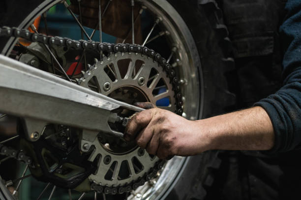istock Crop mechanic changing motorbike chain in workshop 2173088331