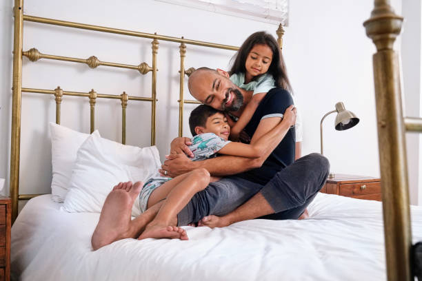 istock Father with children on bed 2173089853