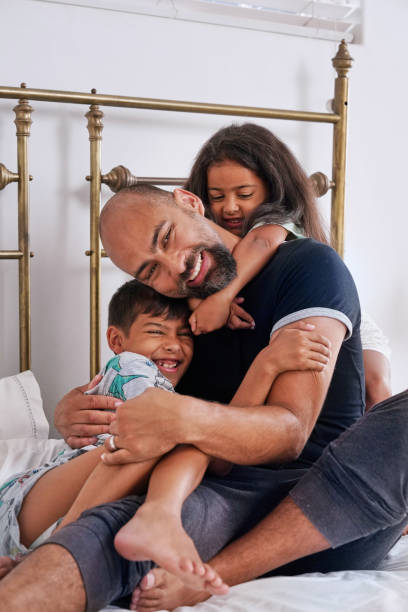 istock Father with children on bed 2173089856