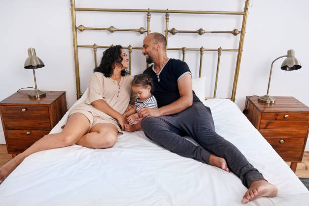 istock Parents with daughter on bed 2173089869