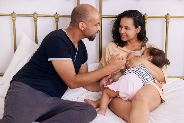istock Parents with daughter on bed 2173089991