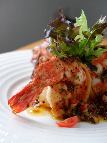 istock Fried prawns with black pepper and garlic in a white plate 2173090362
