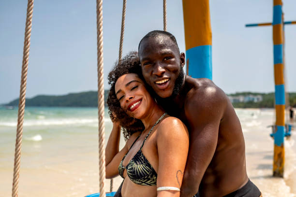 istock Happy Couple Enjoying a Sunny Day on Beach Swing 2173090410