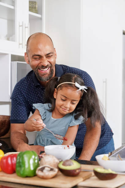 istock Father and daughter preparing food in kitchen 2173090441