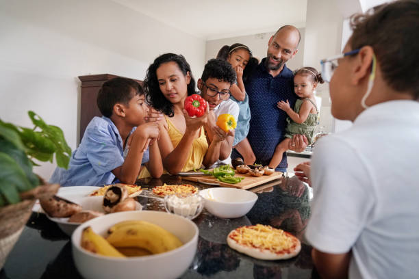 istock Family preparing food in kitchen 2173091420