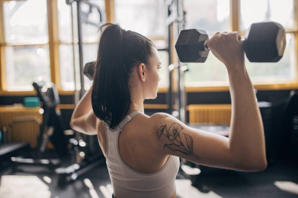 istock Strength training with dumbbells in natural light 2173091743