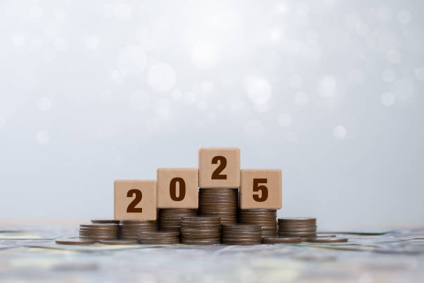 istock 2025 wooden block cube on stack coin for plan, action, goal. financial annual plan for save money, Budget, tax, investment, financial, savings and New Year Resolution retirement concept. 2173092536