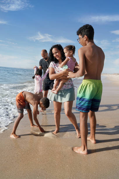 istock Family playing on beach 2173093004