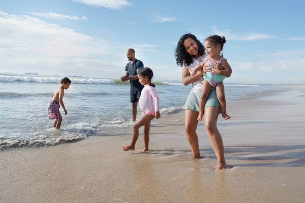 istock Family walking on beach 2173093015