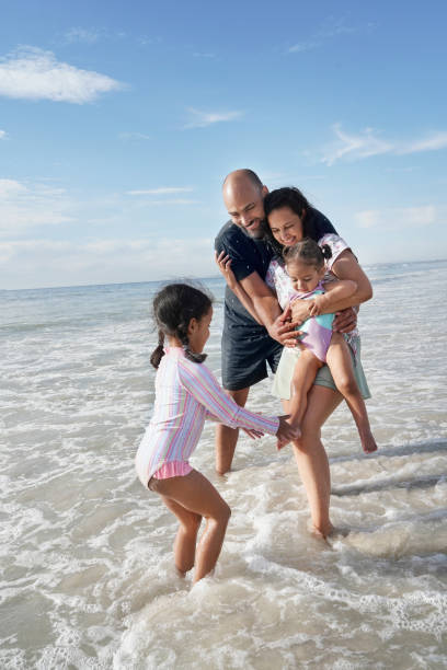 istock Family playing in sea waves 2173093034