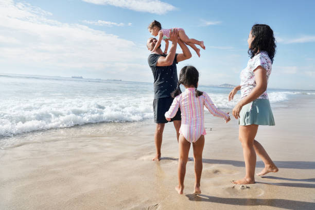 istock Family playing on beach 2173093035