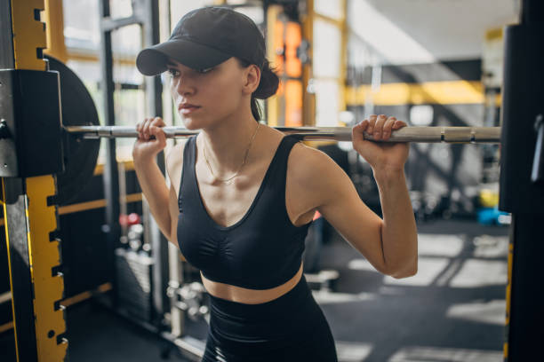 istock Woman lifting weights in a modern gym environment. 2173094320