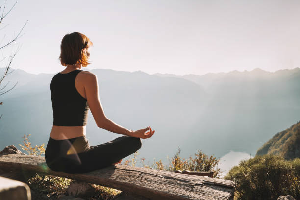 istock Young woman is meditating in mountains. 2173094731