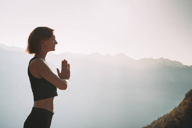 istock Young woman is meditating in mountains. 2173094827