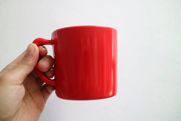istock A asian hand holding a red cup or mug on a plain white background 2173095598
