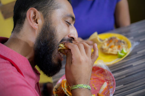 Man eating tacos in taqueria