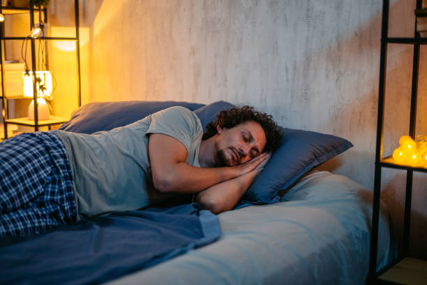 istock Mid-Adult Man Sleeping In The Bed At Night 2173096046