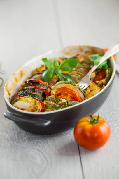 istock prepared baked zucchini and tomatoes in circles in a ceramic form, vegetable snack 2173097146