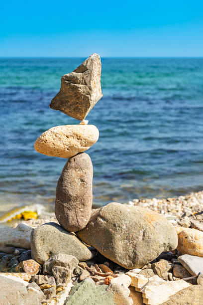 istock Balanced stone sculpture, rocky shore, tranquil sea 2173101294