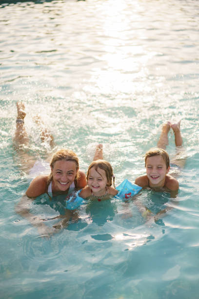 istock Family enjoying in swimming pool 2173103113