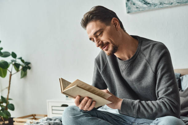 A relaxed evening at home with a handsome man enjoying a good book