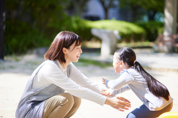 istock A smiling nursery school teacher hugging a child 2173104527