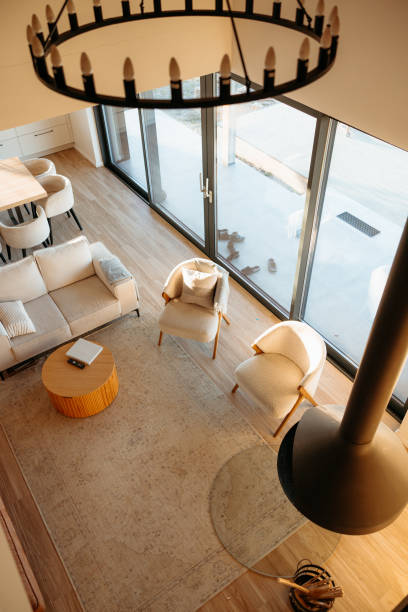 istock Modern cabin interior design with fireplace and large windows overlooking nature 2173110562