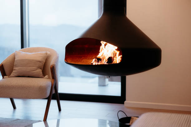 istock Modern hanging fireplace burning in a minimalist cabin interior design 2173110920