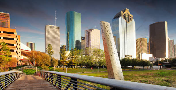 Houston Texas modern skyline at sunset twilight from park lawn