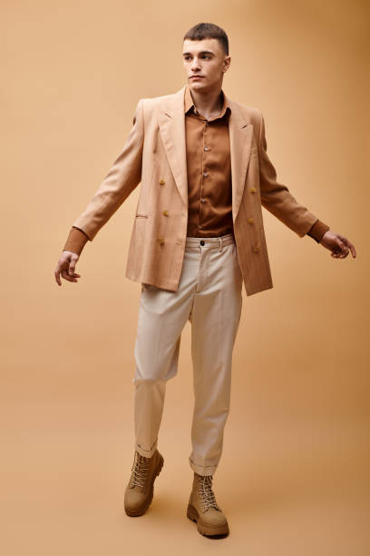 istock Handsome man in stylish attire striking a pose against a vibrant backdrop 2173112693