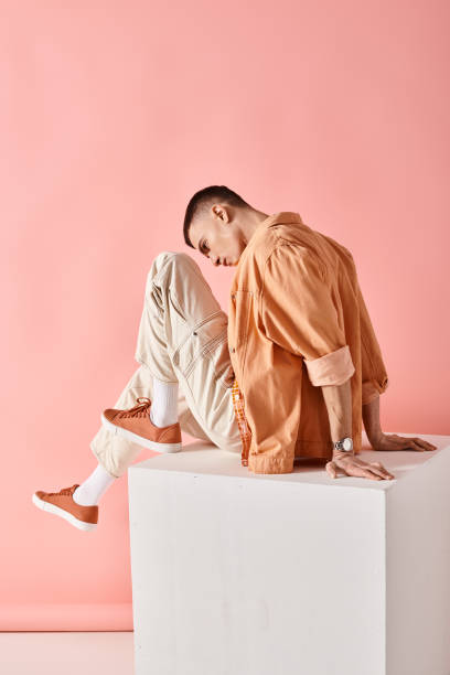 istock A stylish man poses with flair against a vibrant pink backdrop in a creative setting 2173112997