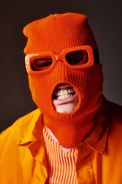 istock A stylishly dressed man poses confidently against a bright, colorful backdrop during a vibrant event 2173115073