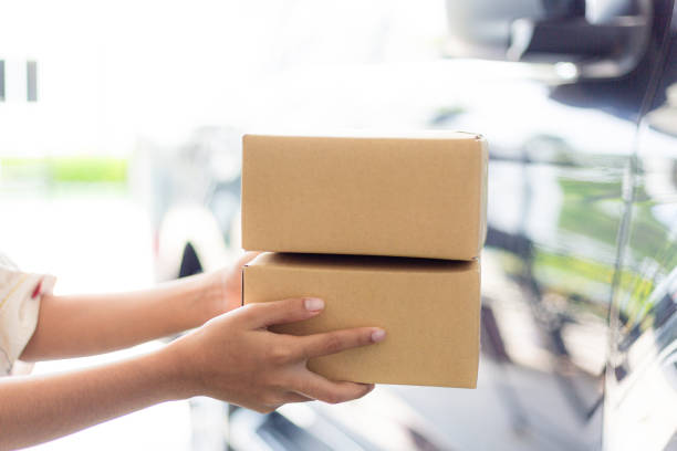 istock Parcel box and human hand,Customer signing document and receiving the parcel from delivery man,Delivery woman delivering box to the man 2173121423