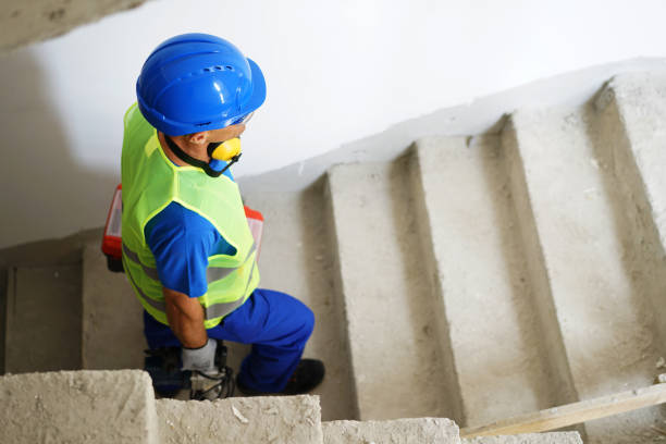 istock A construction worker prepares for work and climbs the stairs. 2173124973
