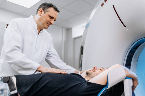 istock A dedicated doctor completes an MRI examination while engaging with a patient. This image showcases professionalism and compassion in healthcare—ideal for medical ads highlighting advanced technology. 2173126445