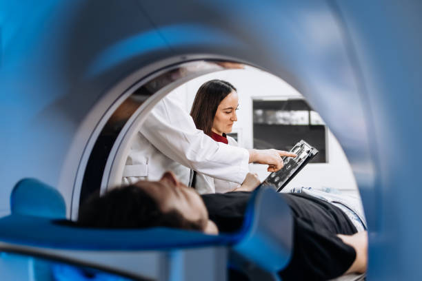 The patient lies inside an MRI or CT machine where the scan is performed. This high-tech equipment represents an innovation in diagnostics, providing accurate information for effective treatment.