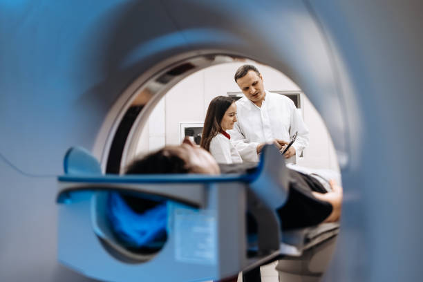 istock A dedicated doctor completes an MRI examination while engaging with a patient. This image showcases professionalism and compassion in healthcare—ideal for medical ads highlighting advanced technology. 2173126885