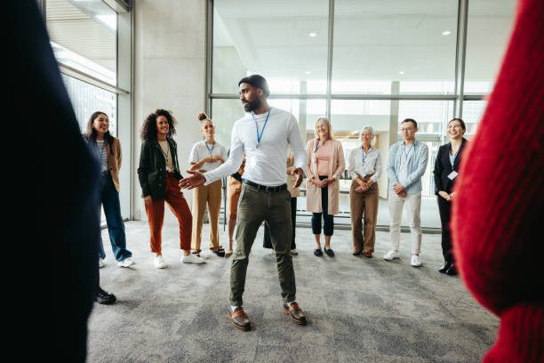 istock Team leader conducting a briefing with a diverse group in a modern office setting 2173129670