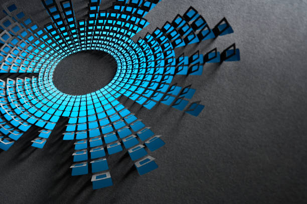 Native image size: 7952 x 5304. Close-up of an intricate cut paper design inspired by an audio spectrum, featuring blue geometric cutouts arranged in a circular pattern on a dark surface, casting bold shadows.