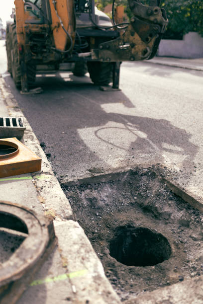 istock Public city street reconstruction with heavy machines. 2173139152