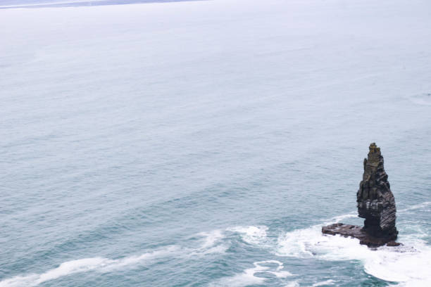 Cliffs of Moher - An Branán Mór Sea Stack in the ocean on a cloudy day