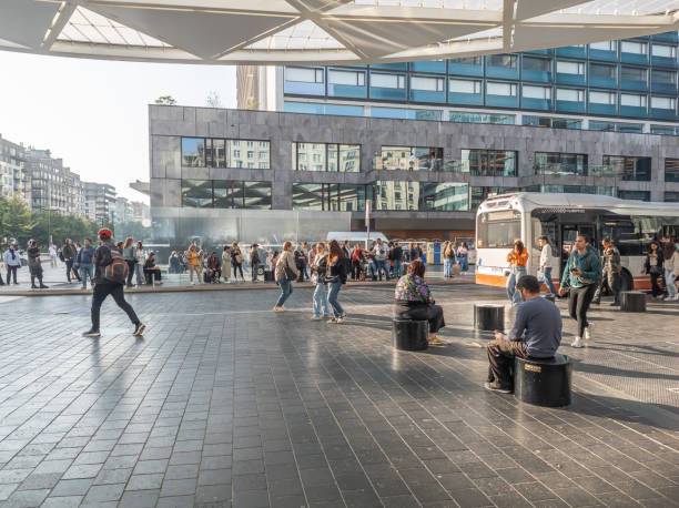 18 july 2024, Brussels, Belgium. Commuters at Rogier bus  stop. commuters going home after work. People of different ethnic origin in the street. Sunny day. City centre. Bus of company \