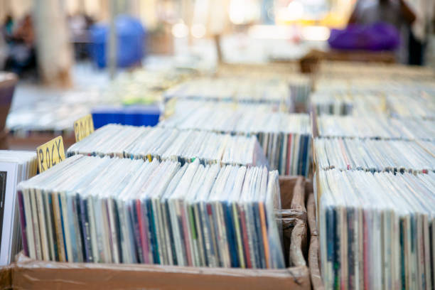 Choosing vinyl record in music record shop stock photo