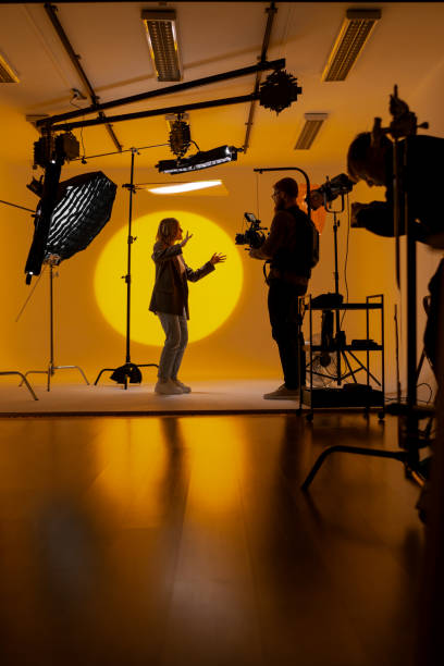 istock Videographer capturing footage in a yellow room with a camera 2173152909
